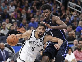 Brooklyn Nets' Spencer Dinwiddie (8) goes to the basket past Orlando Magic's Jonathan Isaac (1) during the second half of an NBA basketball game Friday, Jan. 18, 2019, in Orlando, Fla.