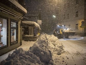 A digger removes shnow in the city center of Miesbach, Germany, Wednesday, Jan. 9, 2019. Due to heavy snow fall the Miesbach county announced a disater alert.
