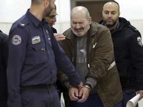 Israeli police escorts a 60-year-old Palestinian Jamil Tamimi into a court in Jerusalem, Thursday, Jan. 10, 2019. Tamimi was sentenced to 18 years for killing British exchange student Hannah Bladon on the Jerusalem light rail in April 2017. Tamimi's defense team claimed he suffered from a mental illness, and the attack was not ideologically or politically motivation.