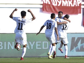 Kyrgyz players celebrate after they scored during the AFC Asian Cup group C soccer match between China and Kyrgyzstan at the Khalifa bin Zayed Stadium in Al Ain, United Arab Emirates, Monday, Jan. 7, 2019.