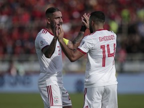 Iran's Ashkan Dejagah, left, and Saman Ghoddos celebrate their team's first goal during the AFC Asian Cup group D soccer match between Iran and Vietnam at Al Nahyan Stadium in Abu Dhabi, United Arab Emirates, Saturday, Jan. 12, 2019.