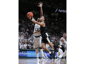 Purdue's Carsen Edwards, front, drives for a layup against Michigan State's Xavier Tillman (23) during the first half of an NCAA college basketball game, Tuesday, Jan. 8, 2019, in East Lansing, Mich.