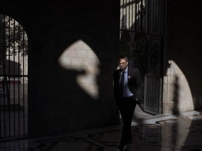 In this Thursday, Jan. 10, 2019 photo, Catalan regional president Quim Torra walks at the Palace of Generalitat or Catalan government headquarters, ahead of an interview with The Associated Press, in Barcelona, Spain. Catalonia separatist leader says that the Spanish government's bid to pass a national budget is doomed unless the wealthy northeastern region is allowed to hold a referendum on secession from the rest of the country.