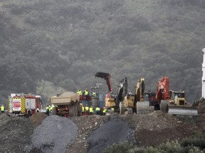 In this photo taken on Sunday, Jan. 20, 2019, drill and excavating machinery work on top of the mountain next to a deep borehole to reach a 2-year-old boy trapped there for six days near the town of Totalan in Malaga, Spain. Spanish officials say rescuers are making slow progress in exceptionally difficult conditions to reach a 2-year-old boy who fell into a narrow, deep borehole in the countryside eight days ago.
