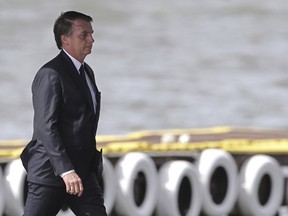 Brazil's President Jair Bolsonaro arrives for the inauguration ceremony of his new naval commander Ilques Barbosa Junior at the Naval Club in Brasilia, Brazil, Wednesday, Jan. 9, 2019.