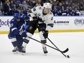 Tampa Bay Lightning left wing Alex Killorn (17) and San Jose Sharks right wing Timo Meier (28) fight for the puck during the first period of an NHL hockey game Saturday, Jan. 19, 2019, in Tampa, Fla.
