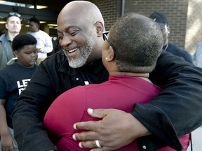 Former felon Desmond Meade and president of the Florida Rights Restoration Coalition, left, hugs Melanie Campbell with the National Coalition Black Civic Participation, after registering to vote at the Supervisor of Elections office Tuesday, Jan. 8, 2019, in Orlando, Fla. Former felons in Florida began registering for elections on Tuesday, when an amendment that restores their voting rights went into effect.
