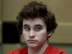 FILE - In this Tuesday, Nov. 27, 2018, file photo, Florida school shooting suspect Nikolas Cruz sits in the courtroom for issues dealing with procedural motions at the Broward Courthouse in Fort Lauderdale, Fla. A status hearing is set for Tuesday, Jan. 8, 2019, for Cruz in the Florida school massacre that killed 17 people in 2018.
