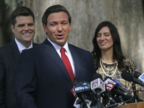 Congressman Matt Gaetz, left, and Lt. Gov. Jeanette Nuñez listen, right, as Florida Gov. Ron DeSantis speaks during a press conference about medical marijuana at Kraft Azalea Park in Winter Park, Fla., on Thursday, Jan. 17, 2019.