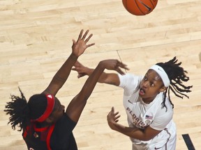 Louisville guard Jazmine Jones (23) shoots over Florida State guard Nicole Ekhomu (12) during the first half of an NCAA college basketball game in Tallahassee, Fla., Thursday, Jan. 24, 2019.