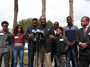 Don Horn, center, Chief Assistant State Attorney for Administration, speaks during a news conference alongside teenagers and their attorneys, Thursday, Jan. 24, 2019, in Miami. Video surfaced of a traffic confrontation between the teens, who were demonstrating in the streets, and Mark Bartlett, who was charged with a weapons violation after he confronted the teens while holding a gun. Prosecutors have begun taking sworn statements from the teens as they weigh possible hate crime charges against Bartlett who confronted them during a housing inequality protest on Martin Luther King Day.