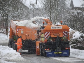 Municipality workers remove snow from a street in Friesenried, southern Germany, Monday, Jan. 7, 2019. Large parts of southern Germany and Austria were hit by heavy snow fall.