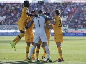 Australia's forward Jamie Maclaren, l2nd right, celebrates with teammates after scoring his side's opening goal during the AFC Asian Cup group B soccer match between Australia and Palestine at Al Maktoum Stadium in Dubai, United Arab Emirates, Friday, Jan. 11, 2019.