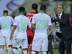 Saudi Arabia's head coach Juan Antonio Pizzi, right, gives instructions to his players during the AFC Asian Cup group E soccer match between Saudi Arabia and North Korea at the Rashid Stadium in Dubai, United Arab Emirates, Tuesday, Jan. 8, 2019.