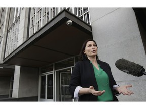 File - In this Jan. 29, 2019, file photo, Amanda Riddle, an attorney representing wildfire victims, speaks with a reporter outside of a Federal Courthouse in San Francisco after Pacific Gas & Electric Corporation filed for bankruptcy. Roughly 1,000 lawsuits representing thousands of people, companies, cities and counties that have been filed since late 2017 demanding that Pacific Gas & Electric Corporation pay for wildfire damages. They range from a rancher's $3,000 small claims complaint to insurance companies' demands for billions of dollars to reimburse their payouts to policyholders.