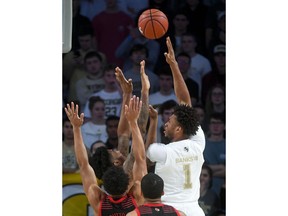 Georgia Tech forward James Banks III (1) puts a shot up over Louisville defenders during the first half of an NCAA college basketball game Saturday, Jan. 19, 2019 in Atlanta.