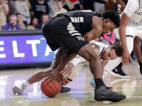Wake Forest forward Jaylen Hoard (10) and Georgia Tech guard Brandon Alston (4) battle for a loose ball during the first half of an NCAA college basketball game, Saturday, Jan. 5, 2019, in Atlanta.
