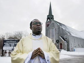 Father Gauthier Elleme poses outside Saint-Paul's church in Saint-Jerome, Que., Saturday, January 5, 2019.