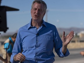 New York Mayor Bill de Blasio, shown in June, announced Tuesday that his city will offer health care to anybody.