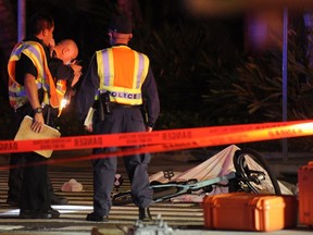 In this photo taken Monday, Jan. 28, 2019, is the scene of a multiple vehicle accident involving two trucks and a bicyclist in Honolulu. Police say a suspected drunk driver in a pickup truck slammed into a crowded Honolulu intersection, killing two pedestrians and a bicyclist and injuring five people including himself. Alcohol and speed may have played a role in the crash shortly before 6:30 p.m. Monday in the Kakaako neighborhood, according to authorities.