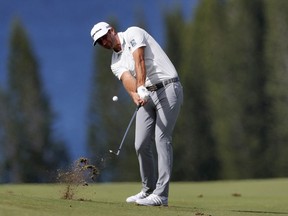 Dustin Johnson hits from the fourth fairway during the first round of the Tournament of Champions golf event, Thursday, Jan. 3, 2019, at Kapalua Plantation Course in Kapalua, Hawaii.