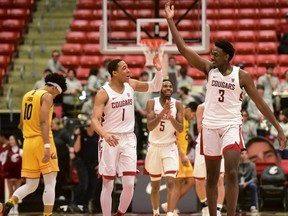 Washington State guard Jervae Robinson (1) and forward Robert Franks (3) celebrate after California coach Wyking Jones called a timeout during the second half of an NCAA college basketball game Thursday, Jan. 17, 2019, in Pullman, Wash. Washington State won 82-59.