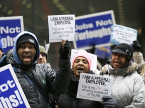Government workers rally against the partial government shutdown at Federal Plaza, Thursday, Jan. 10, 2019, in Chicago. The partial government shutdown continues to drag on with hundreds of thousands of federal workers off the job or working without pay as the border wall fight persists.