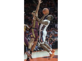 Illinois guard Da'Monte Williams (20) tries to muscle up a shot on Minnesota guard Gabe Kalscheur (22) during the first half of an NCAA college basketball game in Champaign, Ill., Wednesday, Jan. 16, 2019.