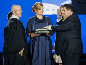 J.B. Pritzker takes the oath of office from Judge James Snyder as his wife M.K. looks on during the Illinois inaugural ceremony at the Bank of Springfield Center Monday, Jan. 14, 2019.