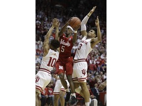 Nebraska's Glynn Watson Jr. (5) puts up a shot against Indiana's Rob Phinisee (10) and Justin Smith (3) during the first half of an NCAA basketball game, Monday, Jan. 14, 2019, in Bloomington, Ind.