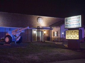 Police lights reflect off the VFW Post 1114, 110 N. Wabash Ave. in Evansville, Ind., after a shooting in the Bingo Hall Sunday, Jan. 13, 2019.  Police say a man opened fire inside a crowded Veterans of Foreign Wars post during a bingo game in Indiana, wounding one person before being tackled by patrons.