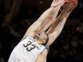 Notre Dame's John Mooney (33) battles for a rebound with Boston College's Nik Popovic during the first half of an NCAA college basketball game Saturday, Jan. 12, 2019, in South Bend, Ind.