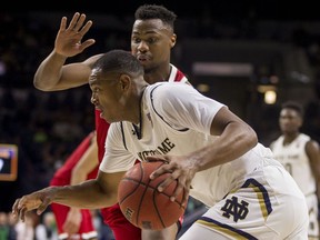 Notre Dame's D.J. Harvey, front, drives against North Carolina State's Torin Dorn during the first half of an NCAA college basketball game, Saturday, Jan. 19, 2019, in South Bend, Ind.