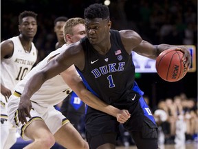 Duke's Zion Williamson (1) is defended by Notre Dame's Dane Goodwin (23) during the first half of an NCAA college basketball game Monday, Jan. 28, 2019, in South Bend, Ind.