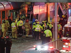 Police and first responders work at the scene where a double-decker city bus struck a transit shelter in Ottawa, on Friday, Jan. 11, 2019.