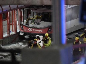 Police and a first responders work at the scene where a double-decker city bus struck a transit shelter in Ottawa, on Friday, Jan. 11, 2019.