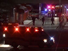 Police and a first responders work at the scene where a double-decker city bus struck a transit shelter in Ottawa, on Friday, Jan. 11, 2019.