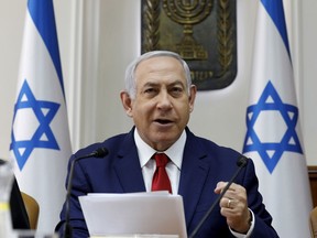 Israeli Prime Minister Benjamin Netanyahu opens the weekly cabinet meeting at the prime minister's office in Jerusalem, Sunday, Jan. 6, 2019.