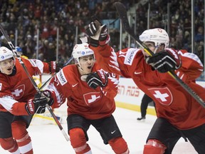 Switzerland's Luca Wyss, right, celebrates his goal past Sweden with teammates Sandro Schmid and Matthew Verboon during s second period IIHF world junior quarterfinal hockey action in Victoria, Wednesday, Jan. 2, 2019.