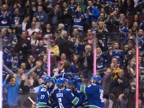 Vancouver Canucks centre Bo Horvat (53) celebrates his goal against the Detroit Red Wings with teammates during third period NHL action in Vancouver, Sunday, Jan 20, 2019.