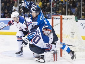 United States' Mattias Samuelsson (24) looks on as Finland's Santeri Virtanen (22) goes over United States goaltender Cayden Primeau (30) during third period IIHF world junior hockey action in Victoria, Monday, Dec. 31, 2018.