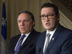 Newly nominated Environment Minister Benoit Charette, right, responds to reporters questions, Tuesday, January 8, 2019 at the legislature in Quebec City. Quebec Premier Francois Legault, left, announced that Charette will replace MarieChantal Chasse who was demoted.