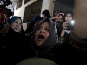 Relatives of Palestinian woman, Amal al-Taramsi, 43, who was killed by Israeli troops during Friday's protest at the Gaza Strip's border with Israel, mourn during her funeral in Gaza City, Saturday, Jan. 12, 2019.