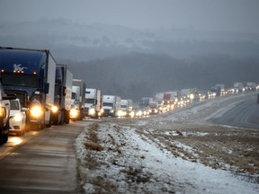 Motorists wait for Interstate 70 to open after it was closed near Manhattan, Kan., due to icy conditions as a winter storm moved through the area Tuesday, Jan. 22, 2019.