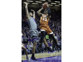 Texas guard Jase Febres (13) shoots after being fouled by Kansas State forward Levi Stockard III (34) during the first half of an NCAA college basketball game in Manhattan, Kan., Wednesday, Jan. 2, 2019.