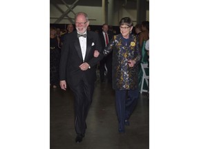 Kansas Gov. Laura Kelly, right, is escorted by her husband, Ted Daugherty, during the entrance procession of her inaugural ball, Monday, Jan. 14, 2019, in Topeka, Kan.