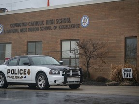 A police car sits in front of Covington Catholic High School in Park Hills, Ky., Saturday, Jan 19, 2019. A diocese in Kentucky apologized Saturday after videos emerged showing students from the Catholic boys' high school mocking Native Americans outside the Lincoln Memorial on Friday after a rally in Washington.