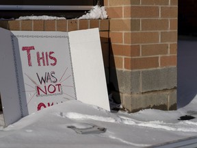 A sign reading "This was not okay," is seen in front of Covington Catholic High School in Park Kills, Ky., Sunday, Jan 20, 2019. A diocese in Kentucky has apologized after videos emerged showing students from the Catholic boys' high school mocking Native Americans outside the Lincoln Memorial on Friday after a rally in Washington.