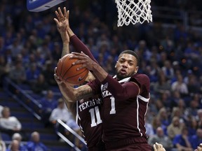 Texas A&M's Savion Flagg (1) pulls down a rebound next to teammate Wendell Mitchell (11) during the first half of an NCAA college basketball game in Lexington, Ky., Tuesday, Jan. 8, 2019.
