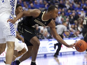 Vanderbilt's Joe Toye (2) drives around Kentucky's Nick Richards (4) during the first half of an NCAA college basketball game in Lexington, Ky., Saturday, Jan. 12, 2019.